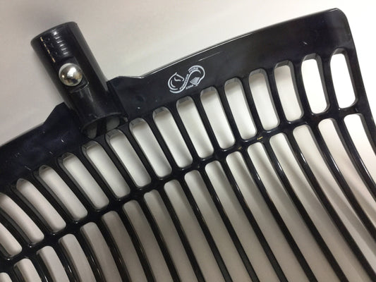 Close-up of the Forever Fork Black Head by Forever Fork, showing the black plastic rake head with included hardware and metal screw. A white logo is visible on the top edge, photographed against a light background.